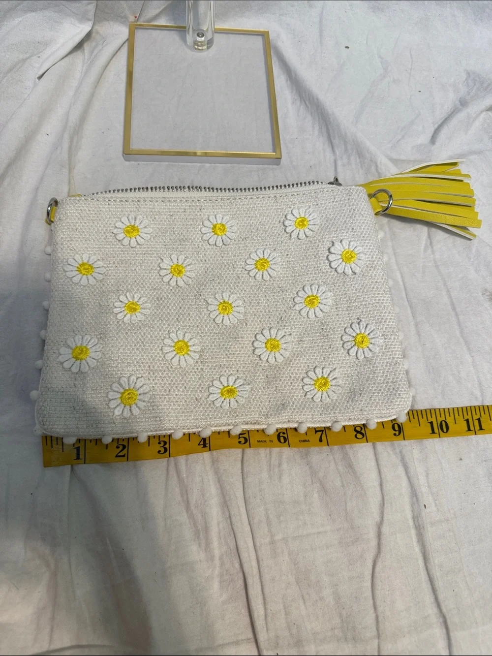 White Daisy-Embroidered Wristlet Clutch with Yellow Tassel